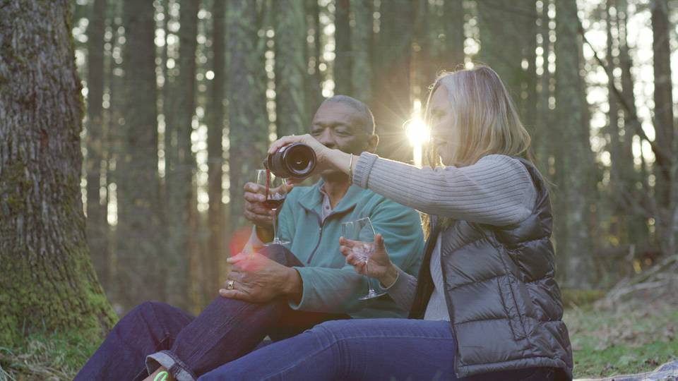 Couple Pours Wine in Woods Stock Video Footage