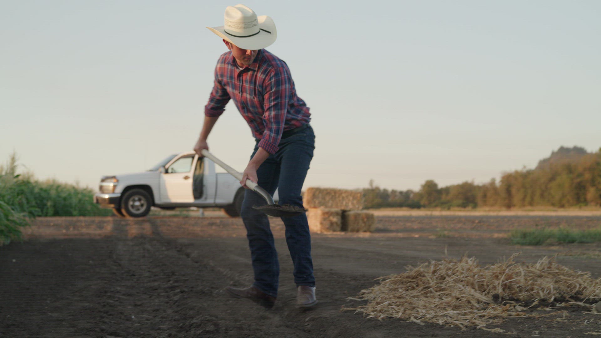 Young Farmer Digging A Hole In The Crop Field | Stock Video Footage